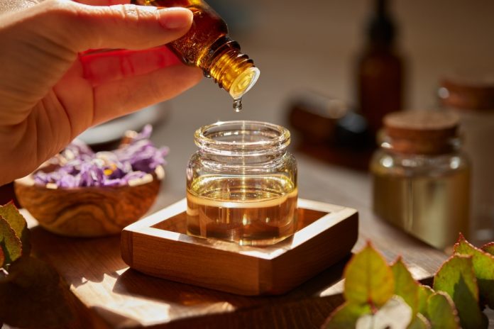 preparing,massage,oil,dropping,essential,oil.,woman,dripping,aromatic,essential
